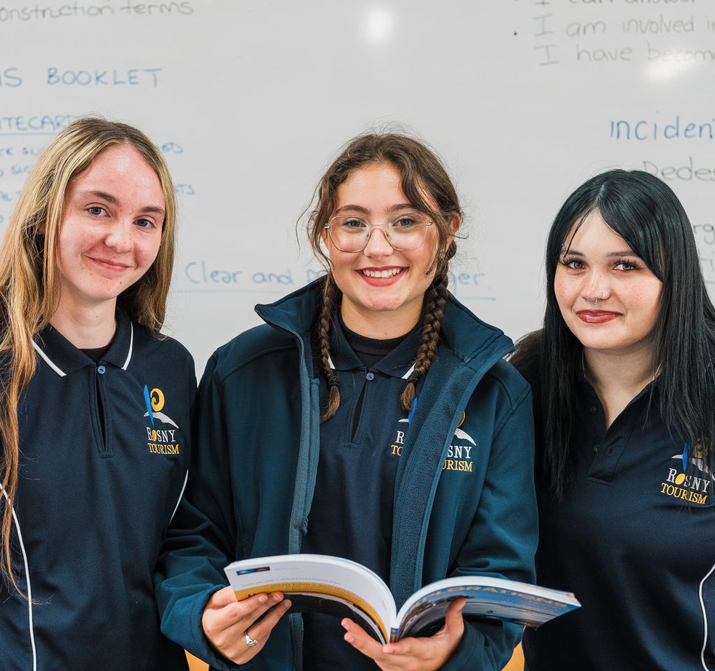 Photo of three Rosny College tourism students in front of a whiteboard (2025)